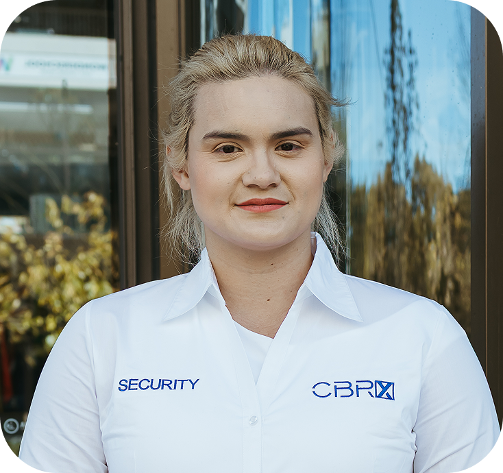 Security guard wearing CBRX-labeled white shirt, representing a Canberra security company.